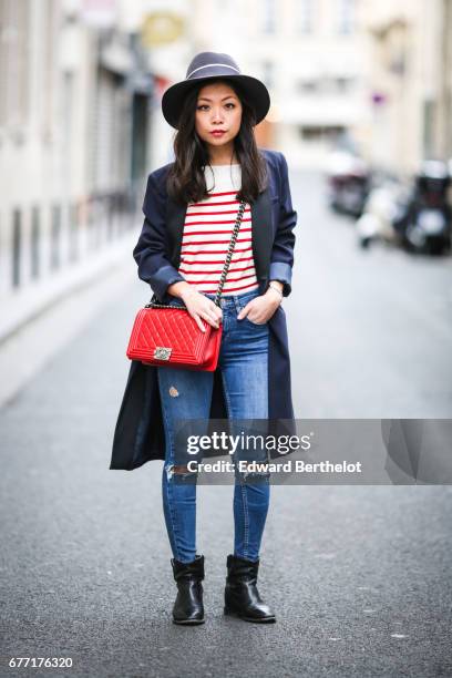 May Berthelot, fashion blogger and Head of Legal at Videdressing.com, wears a Maison Michel hat, a Sezane red and white striped top, Topshop ripped...