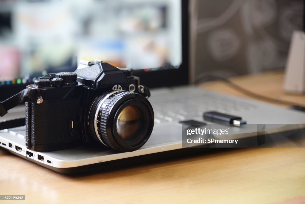 Digital Studio Photography Workstation. Retro film DSLR Camera, Laptop Computer Screen and flash drive memory card