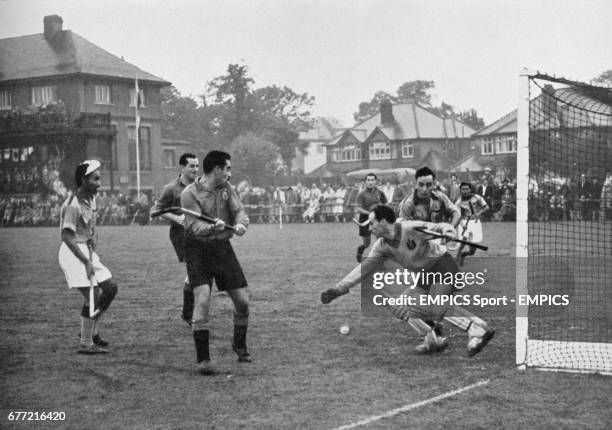 Spain goalkeeper Rafael Ruiz attempts to save from India's Grahanandan Singh during the group game. India won the match 2-0 and went on to win the...