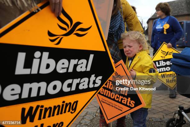 Angus Braden of Oxfordshire cries as Liberal Democrat party campaign signs are held before Liberal Democrat leader Tim Farron arrives for an event on...