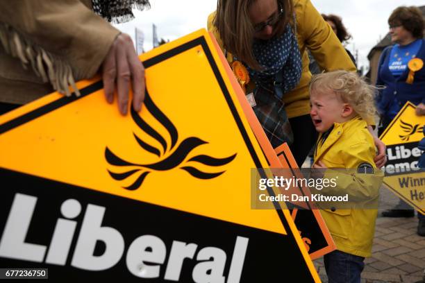 Angus Braden of Oxfordshire cries as Liberal Democrat party campaign signs are held before Liberal Democrat leader Tim Farron arrives for an event on...