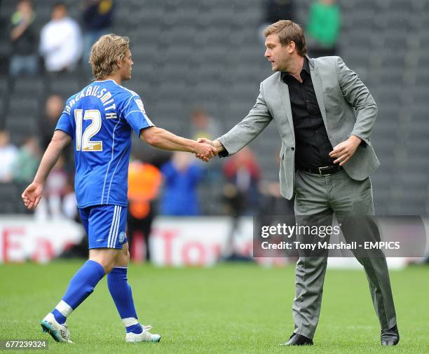 Milton Keynes Dons manager Karl Robinson shakes hands with Peterborough United goalscorer Craig Mackail-Smith afer the final whsitle