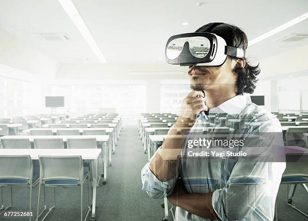 man using a virtual reality headset. - virtual reality classroom stock pictures, royalty-free photos & images