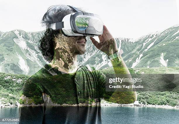 man using a virtual reality headset. - lunettes 3d photos et images de collection
