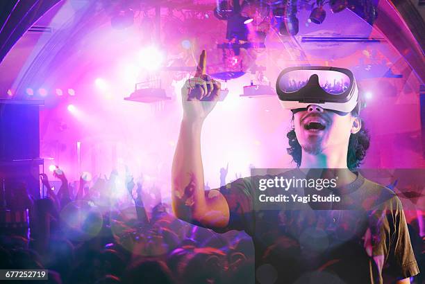 man enjoying a club night in a virtual reality - virtual concert stock pictures, royalty-free photos & images