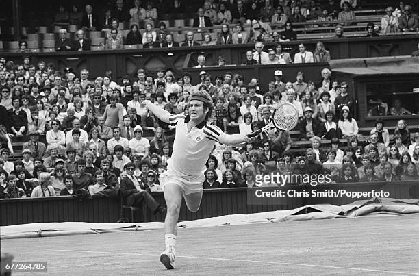 American tennis player John McEnroe pictured in action in his third round match against Dutch tennis player Tom Okker at the Wimbledon Lawn Tennis...