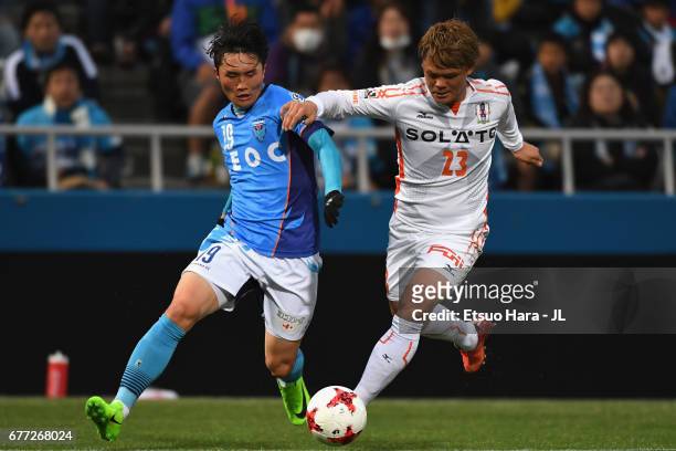 Jeong Chung Geun of Yokohama FC and Makoto Rindo of Ehime FC compete for the ball during the J.League J2 match between Yokohama FC and Ehime FC at...