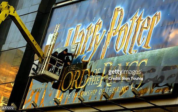 The cinema sign for the film Harry Potter is replaced by the new Lord of the Rings movie poster in preparation for the film's World Premiere at the...