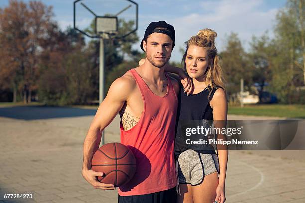 portrait of young couple with basketball - philipp nemenz foto e immagini stock