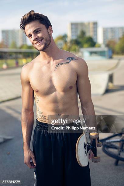 young tattood men with skateboard smiling - philipp nemenz bildbanksfoton och bilder