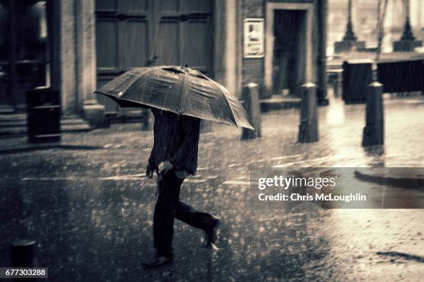 heavy rain in leeds - torrential rain umbrella stock pictures, royalty-free photos & images