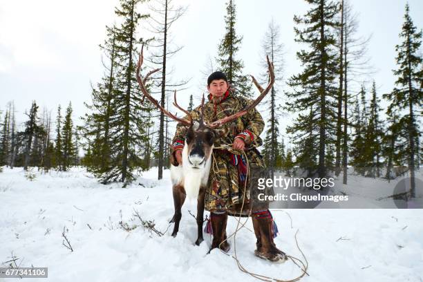 siberian herder with reindeer in forest - nenets stock pictures, royalty-free photos & images