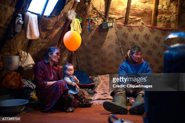nenets family resting in tent - nenets stock pictures, royalty-free photos & images