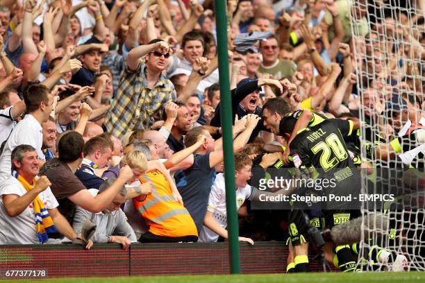 Leeds United fans mob Adam Clayton after he scored their equalising goal
