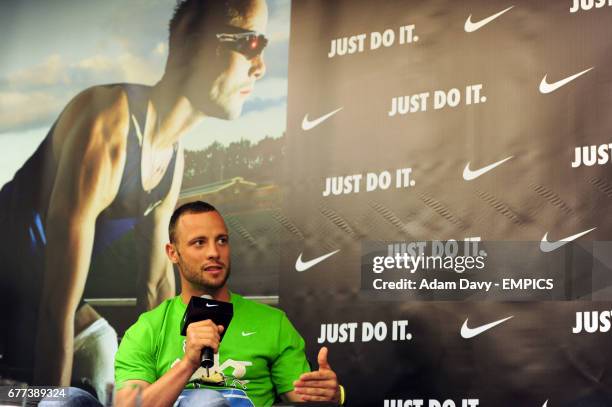 South Africa's Oscar Pistorius talks to the press during a press conference