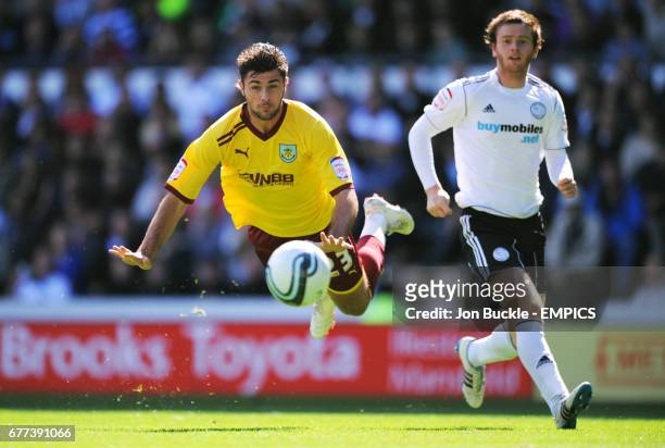 Burnley's Charlie Austin dives for a header as Derby County's John Brayford watches on