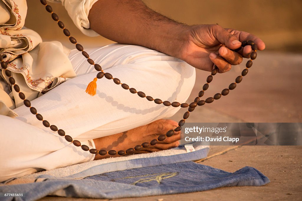 Prayer beads, a man meditating, Varanasi, India