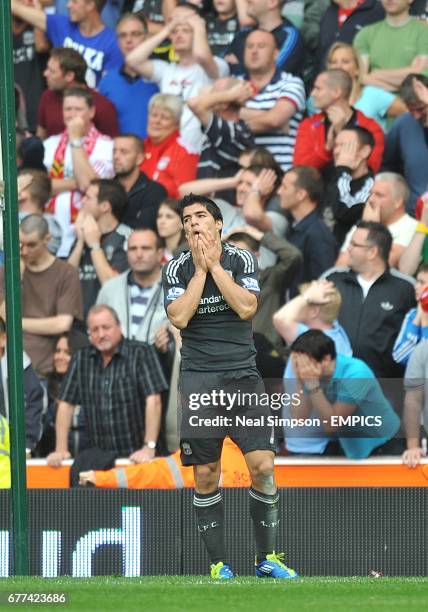 Liverpool's Luis Suarez reacts after an accidental handball by Stoke City's Matthew Upson