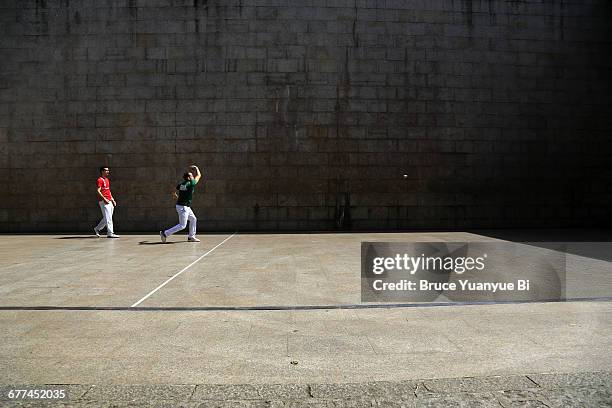 locals playing basque pelota on street court - baskische provinz stock-fotos und bilder