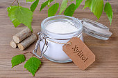 sugar substitute xylitol, a glass jar with birch sugar, liefs and wood