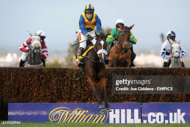 Notus de La Tour ridden by Tom Scudamore jumps the last fence and goes on to win The Edinburgh Woollen Mill Novices' Steeple Chase