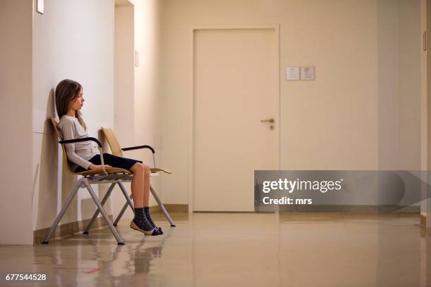 young girl in hospital waiting room - waiting room stockfoto's en -beelden