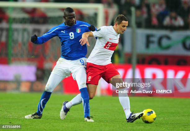 Poland's Dariusz Dudka and Italy's Mario Balotelli battle for the ball
