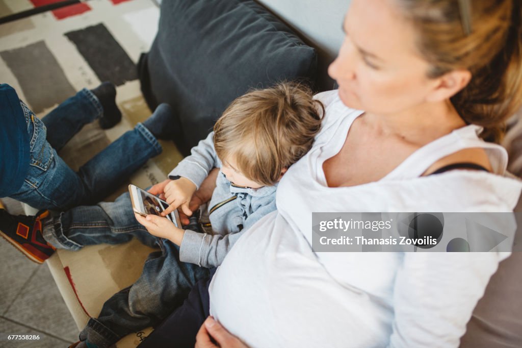 Mother with her kids looking a smartphone