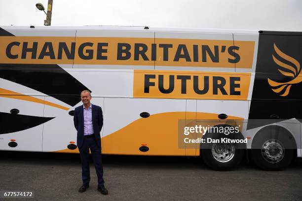 Liberal Democrat leader Tim Farron stands next to the Liberal Democrat 'Battle Bus' after a campaign event on May 3, 2017 in Kidlington, a village...