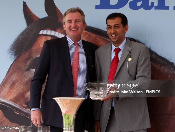 Trainer Mahmood Al Zarooni is presented with a trophy after his horse Blue Bunting won the Darley Yorkshire Oaks