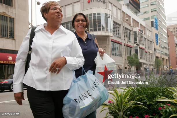 Couple of women with shopping bags in Fountain Square.