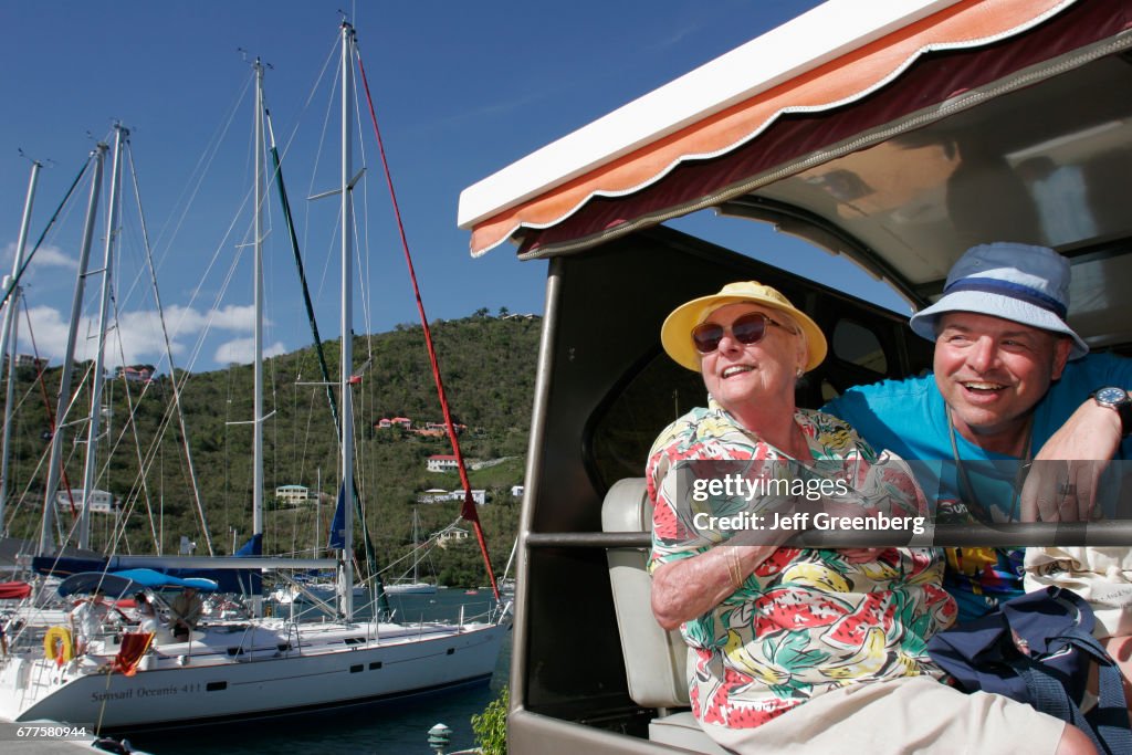 A couple in a tour vehicle at Soper's Hole Wharf and Marina.