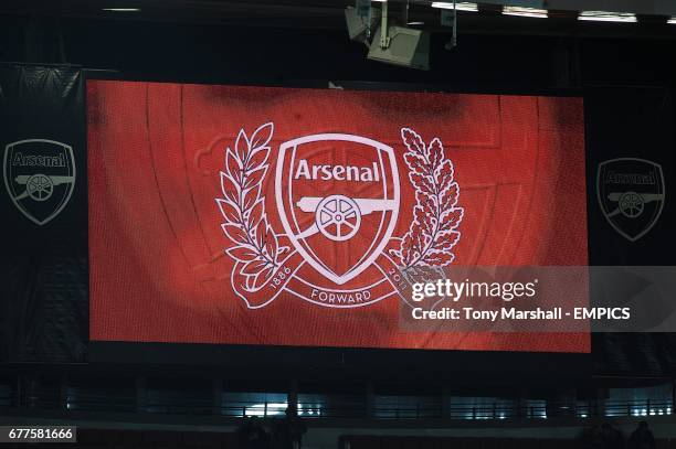 The Arsenal crest is displayed on the video screen at the Emirates Stadium before the game