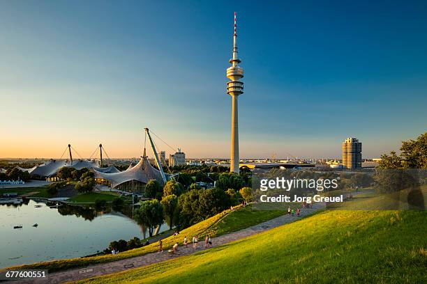 olympiapark and olympiaturm at sunset - münchen stockfoto's en -beelden