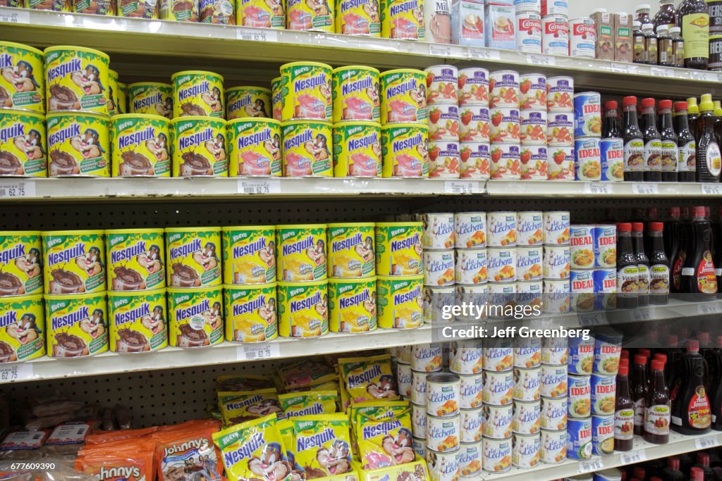 Shelves of chocolate milk powder for sale at La Colonia Supermarket.