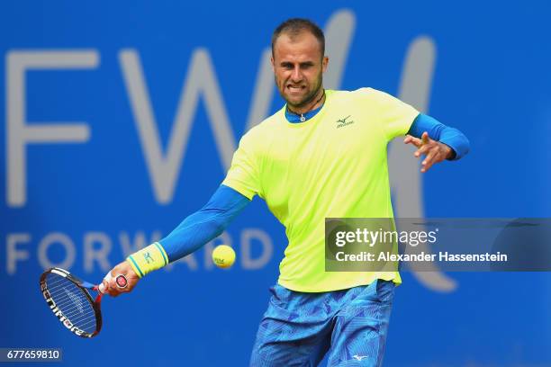 Marius Copil of Rumania plays the ball against Roberto Bautista Agut of Spain during their 2. Round match of the 102. BMW Open by FWU at Iphitos...