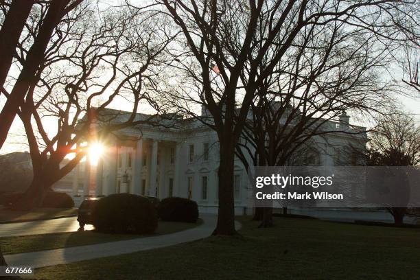 The early morning sun rises behind the White House before shots were fired near the south lawn February 7, 2001 in Washington, DC. Secret Service...