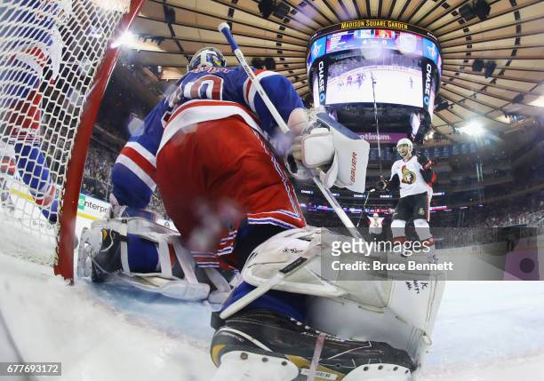 The Ottawa Senators celebrate a goal against Henrik Lundqvist of the New York Rangers in Game Three of the Eastern Conference Second Round during the...