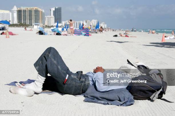 Miami Beach Homeless Man on crowded Beach.