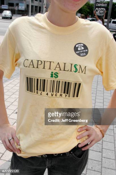 Torch of Friendship, corporate greed protest t-shirt.