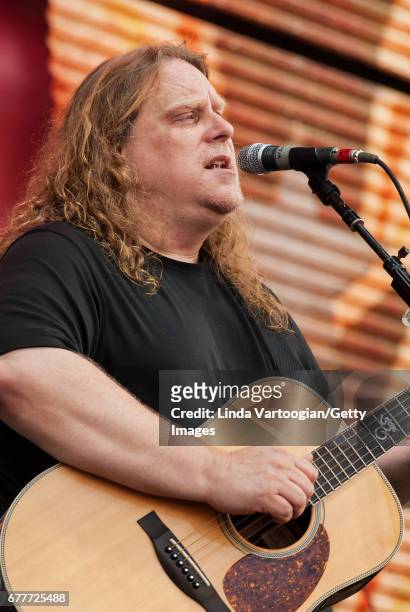 American Rock musician Warren Haynes plays guitar as he performs with the Allman Brothers Band on stage at the 22nd Annual Farm Aid concert at...