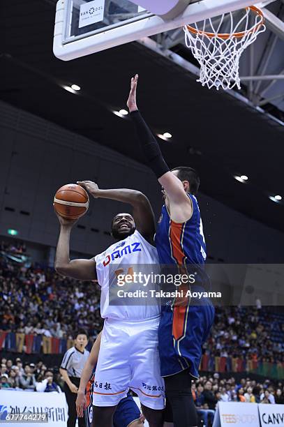 Davante Gardner of the Niigata Albirex BB tries to shoot under pressure from Jason Washburn of the Yokohama B-Corsairs during the B. League match...