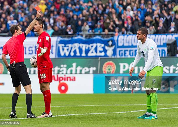 Referee Markus Schmidt shows Jeffrey Bruma of VfL Wolfsburg the red card during the Bundesliga match between SV Darmstadt 98 and VfL Wolfsburg at...