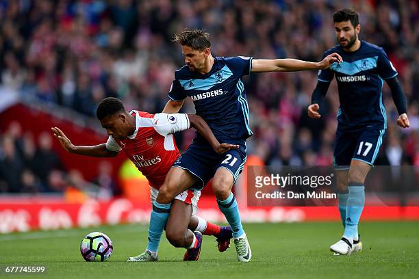 Gaston Ramirez of Middlesbrough tackles Alex Iwobi of Arsenal during the Premier League match between Arsenal and Middlesbrough at Emirates Stadium...