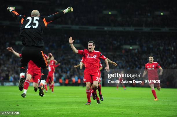 Liverpool's Jose Pepe Reina celebrates as his team mates run towards him, after Cardiff City's Anthony Gerrard's shot on goal goes wide during the...