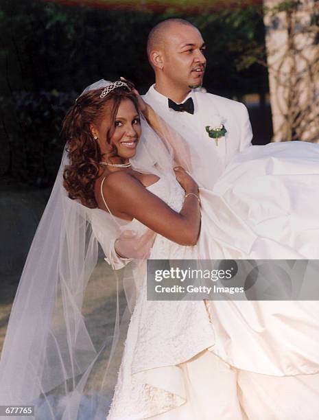 Tony Braxton and her husband Keri Lewis, keyboardist for the band Mint Condition, kid around on their wedding day April 21, 2001 in Alpharetta, GA....