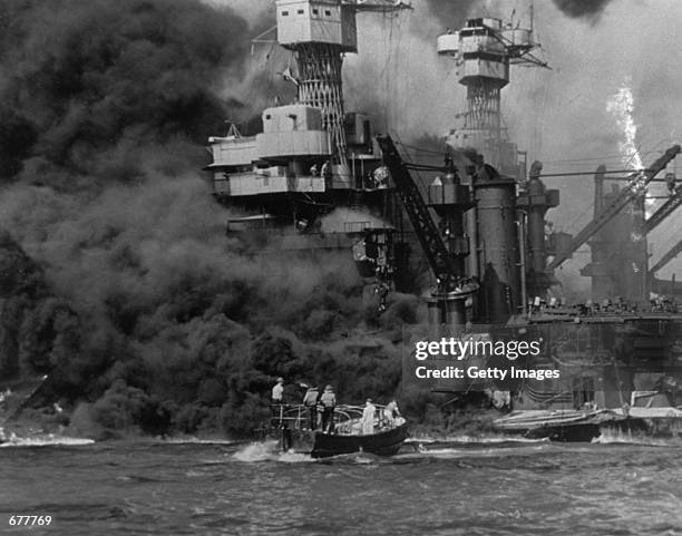 Small boat rescues sailors December 7, 1941 from the USS West Virginia after she had suffered a hit in the Japanese attack on Pearl Harbor. The USS...