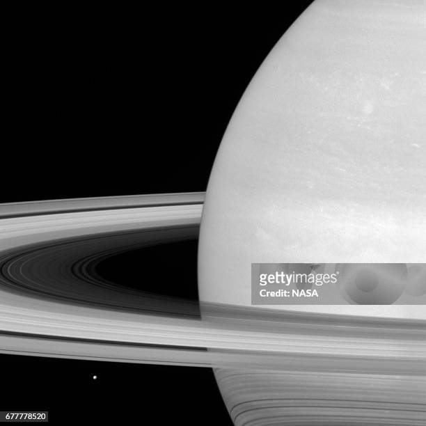 In this handout image provided by the National Aeronautics and Space Administration , Saturn's icy moon Mimas is seen while looking toward the sunlit...