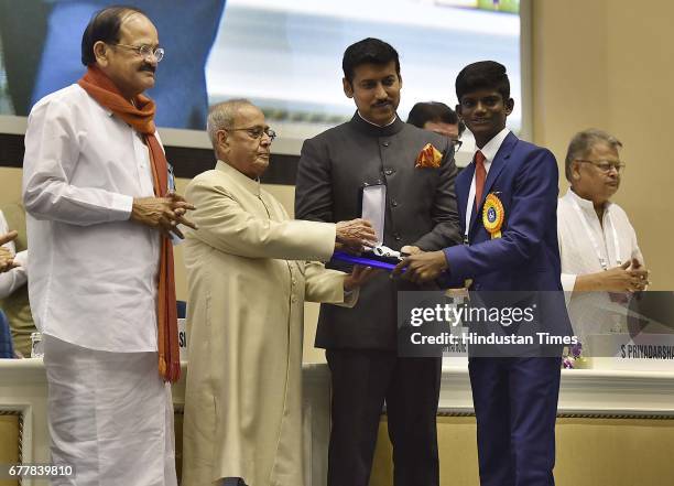 President Pranab Mukherjee presents Best Child Artist award to Manohara. K for Railway Children during the 64th National Film Awards at Vigyan...