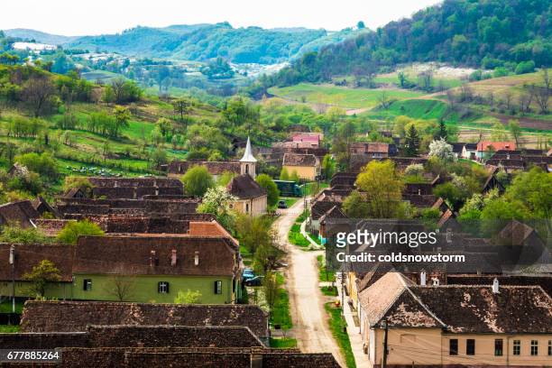 aerial view of the romanian village of copsa mare, transylvania, romania - romania village stock pictures, royalty-free photos & images